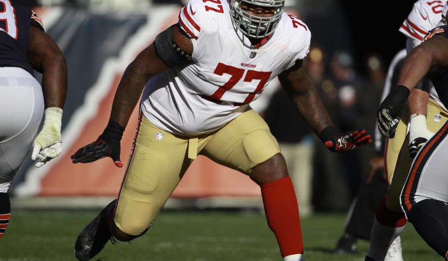 FILE - In this Dec. 3, 2017, file photo, San Francisco 49ers offensive tackle Trent Brown (77) sets to block against the Chicago Bears during an NFL football game in Chicago. The 49ers have traded right tackle Trent Brown to the New England Patriots a day after drafting Mike McGlinchey as his replacement in the first round. A person familiar with the trade said the 49ers dealt Brown and the 143rd overall pick to New England on Friday, April 27, 2018, for the 95th overall pick. The person spoke on condition of anonymity because the deal had not been announced.(AP Photo/Jeff Haynes, File)