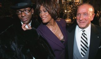 FILE - In this Feb. 24, 1998 file photo, singers Bobby Brown, from left, and Whitney Houston appear with music producer Clive Davis at a pre-Grammy party in New York. Brown’s daughter Bobbi Kristina Brown is one of the toughest moments his biopic explores in “The Bobby Brown Story,” airing on BET in September. The miniseries details the rise of Brown who was considered one of R&amp;amp;B’s “bad boys” after his highly-publicized drug use and tumultuous marriage with Houston. (AP Photo/Stuart Ramson, File)
