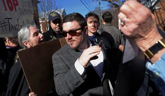 In this Feb. 27, 2018, file photo, Jason Kessler walks through a crowd of protesters in front of the Charlottesville Circuit Courthouse ahead of a decision regarding the covered Confederate statues, during a rally in Charlottesville, Va. (Zack Wajsgras/The Daily Progress via AP)