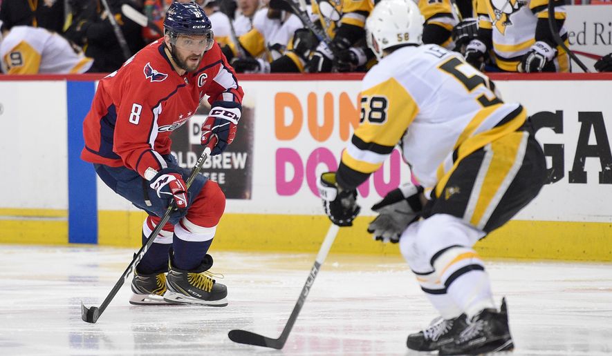 Washington Capitals left wing Alex Ovechkin (8), of Russia, skates with the puck against Pittsburgh Penguins defenseman Kris Letang (58) during the second period in Game 1 of an NHL second-round hockey playoff series, Thursday, April 26, 2018, in Washington. (AP Photo/Nick Wass) ** FILE **