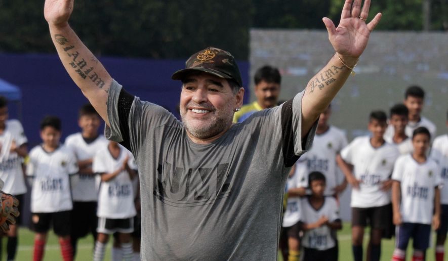 FILE - In this Dec. 12, 2017, file photo, Diego Maradona gestures as he attends a football clinic and workshop for young aspiring soccer players in Kadambagachhi, north of Kolkata, India.  Diego Maradona has left his coaching job in the United Arab Emirates after the team he was in charge of failed to win automatic promotion to the premier division. (AP Photo/Bikas Das, File)