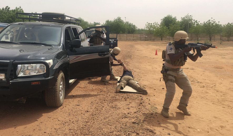 In this photo taken Friday, April 13, 2018. Nigerien police who are part of the U.S. Special Program for Embassy Augmentation and Response, known as SPEAR take part in the annual U.S.-led Flintlock exercise in Niamey, Niger. Amid questions over the role of the U.S. military in West Africa's vast Sahel region, the State Department is pouring millions of dollars into training local law enforcement officers in the hopes that extremism can be better countered at the community level. (AP Photo/Carley Petesch)