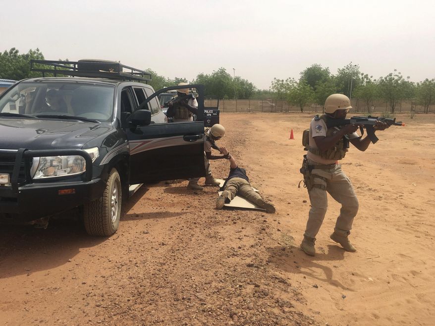 In this photo taken Friday, April 13, 2018. Nigerien police who are part of the U.S. Special Program for Embassy Augmentation and Response, known as SPEAR take part in the annual U.S.-led Flintlock exercise in Niamey, Niger. Amid questions over the role of the U.S. military in West Africa's vast Sahel region, the State Department is pouring millions of dollars into training local law enforcement officers in the hopes that extremism can be better countered at the community level. (AP Photo/Carley Petesch)
