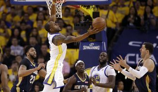 Golden State Warriors&#x27; Andre Iguodala, top, grabs a rebound against the New Orleans Pelicans during the first half in Game 1 of an NBA basketball second-round playoff series Saturday, April 28, 2018, in Oakland, Calif. (AP Photo/Marcio Jose Sanchez)