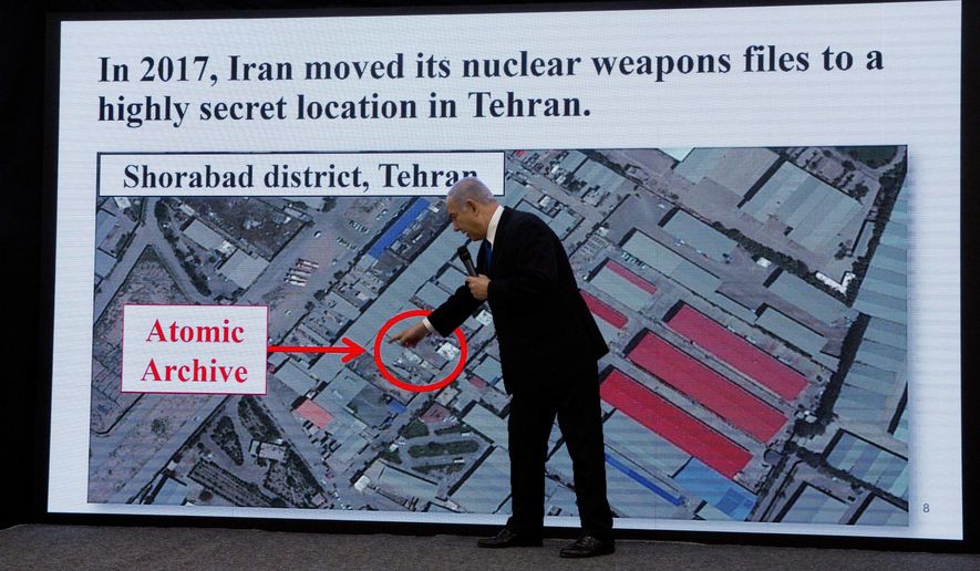 Israeli Prime Minister Benjamin Netanyahu presents material on Iranian nuclear weapons development during a press conference in Tel Aviv, Monday, April 30 2018. Netanyahu says his government has obtained &quot;half a ton&quot; of secret Iranian documents proving the Tehran government once had a nuclear weapons program. Calling it a &quot;great intelligence achievement,&quot; Netanyahu said Monday that the documents show that Iran lied about its nuclear ambitions before signing a 2015 deal with world powers. (AP Photo/Sebastian Scheiner)