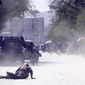 A security force and a civilian lie low at the site of a suicide attack after the second bombing in Kabul, Afghanistan, Monday, April 30, 2018. A coordinated double suicide bombing hit central Kabul on Monday morning, (AP Photo/Massoud Hossaini) ** FILE **