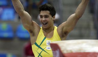 FILE - In this Oct. 25, 2011 file photo, Brazil&#39;s Petrix Barbosa celebrates after competing on the vault at the men&#39;s artistic gymnastics team qualifications and finals of the Pan American Games in Guadalajara, Mexico. A community center has fired on Monday, April 20, 2018, a former coach of the Brazilian national gymnastics team after a news report revealed that dozens of athletes he worked with have accused him of sexual abuse. One of those, Petrix Barbosa, said the abuse started when he was 10 or 11. &amp;quot;I woke up with him, I don&#39;t know how many times, with his hand down my pants,&amp;quot; said Barbosa, who was a gold medalist at the Pan American Games in 2011. (AP Photo/Dario Lopez-Mills, File)