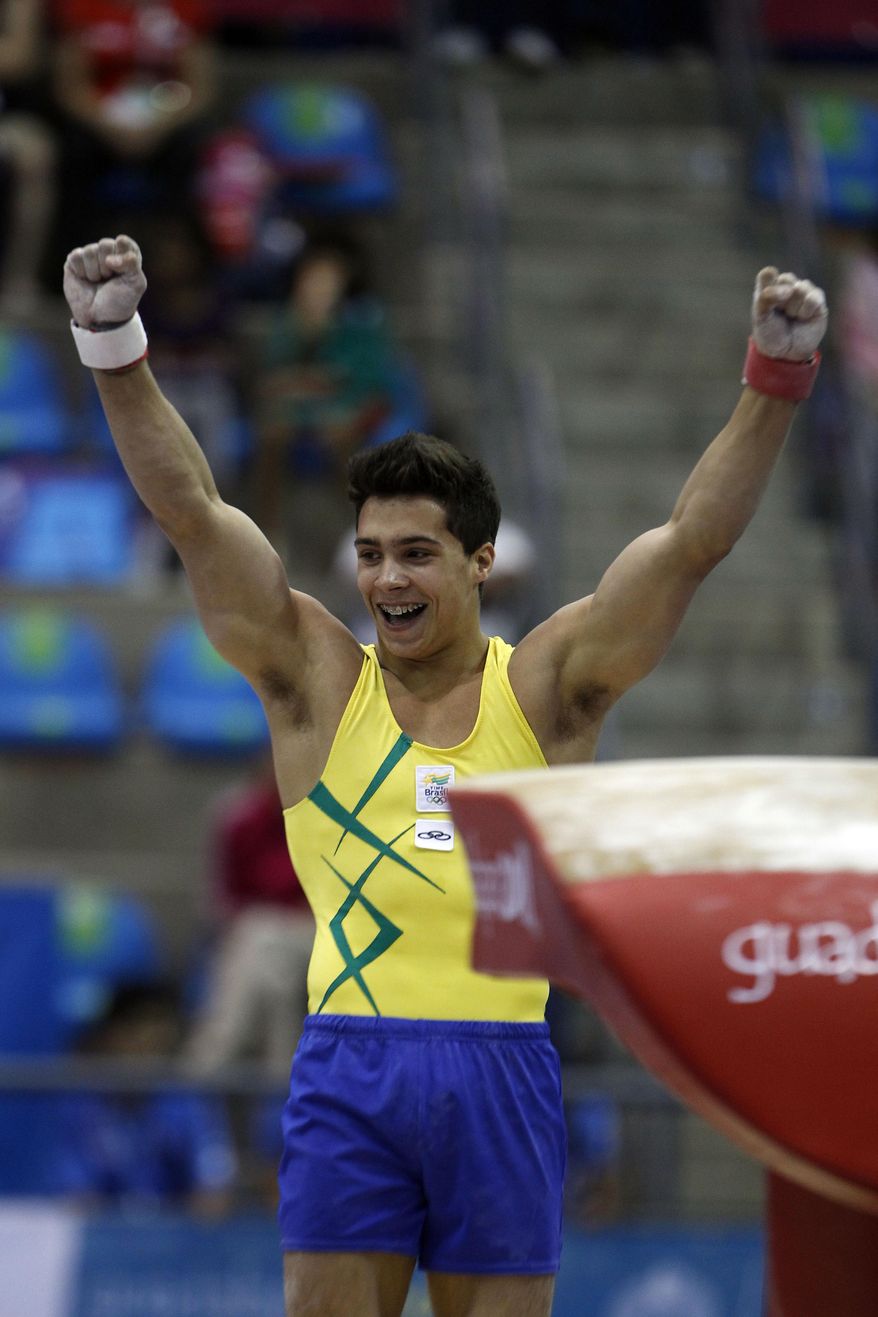 FILE - In this Oct. 25, 2011 file photo, Brazil&#39;s Petrix Barbosa celebrates after competing on the vault at the men&#39;s artistic gymnastics team qualifications and finals of the Pan American Games in Guadalajara, Mexico. A community center has fired on Monday, April 20, 2018, a former coach of the Brazilian national gymnastics team after a news report revealed that dozens of athletes he worked with have accused him of sexual abuse. One of those, Petrix Barbosa, said the abuse started when he was 10 or 11. &amp;quot;I woke up with him, I don&#39;t know how many times, with his hand down my pants,&amp;quot; said Barbosa, who was a gold medalist at the Pan American Games in 2011. (AP Photo/Dario Lopez-Mills, File)