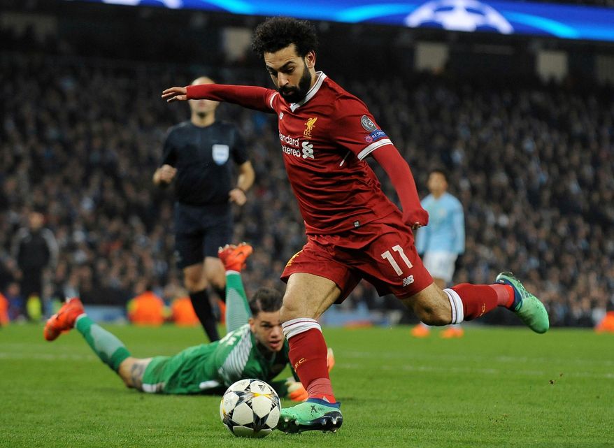 FILE - In this April 10, 2018, file photo, Liverpool&#39;s Mohamed Salah scores his side&#39;s first goal during the Champions League quarterfinal second leg soccer match against Manchester City  in Manchester, England. Premier League leading scorer Salah said Sunday, April 29, 2018, he is insulted over the unauthorized use of his image and blames the Egyptian Football Association in a dispute that comes less than two months before the World Cup in Russia. (AP Photo/Rui Vieira, File)