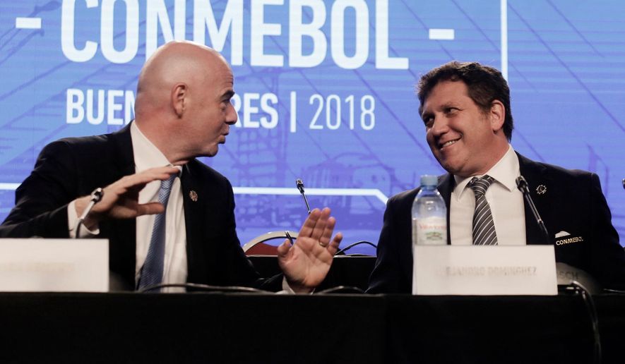 FILE - In this Thursday, April 12, 2018 file photo, FIFA President Gianni Infantino, left, talks with Alejandro Dominguez, right, president of the South American Football Confederation, CONMEBOL, during their annual conference in Buenos Aires, Argentina. FIFA hosted talks Monday April 30, 2018, with football’s six continental governing bodies about a $25 billion offer to run two international competitions, seeking agreement before the World Cup kicks off in June. (AP Photo/Martin Ruggiero, File)