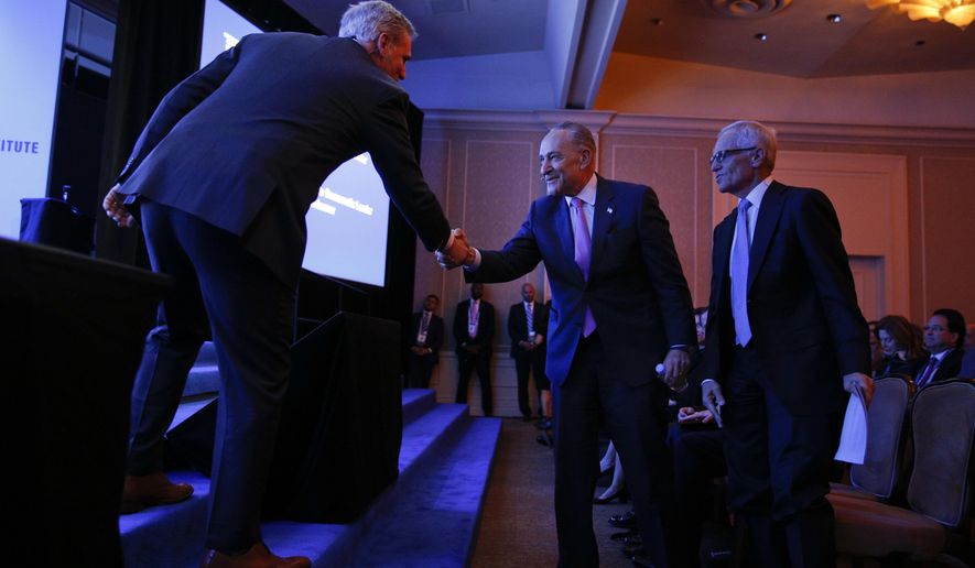 Senate Minority Leader Chuck Schumer, D-N.Y., center, shakes hands with House Majority Leader Kevin McCarthy, R-Calif., at the Milken Institute Global Conference Monday, April 30, 2018, in Beverly Hills, Calif. (AP Photo/Jae C. Hong)