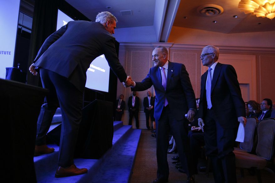 Senate Minority Leader Chuck Schumer, D-N.Y., center, shakes hands with House Majority Leader Kevin McCarthy, R-Calif., at the Milken Institute Global Conference Monday, April 30, 2018, in Beverly Hills, Calif. (AP Photo/Jae C. Hong)
