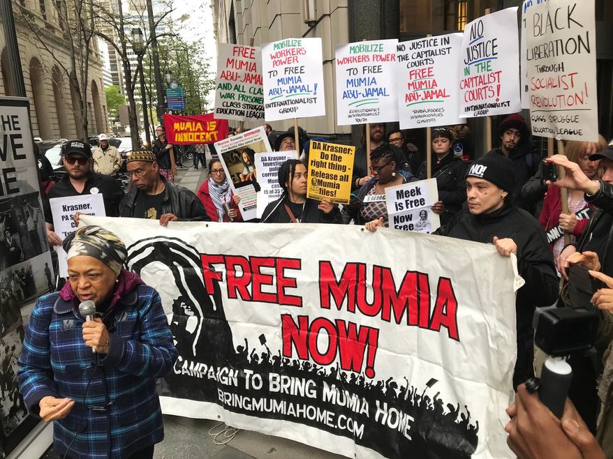 Supporters of Mumia Abu-Jamal, convicted in the 1981 murder of white Philadelphia police Officer Daniel Faulkner, gather outside the Criminal Justice Center in Center City Philadelphia on Monday, April 30, 2018. Former death-row inmate Abu-Jamal is in court asking a judge to vacate his previous failed appeals attempts, so he can again appeal his case. (Jessica Griffin/The Philadelphia Inquirer via AP)