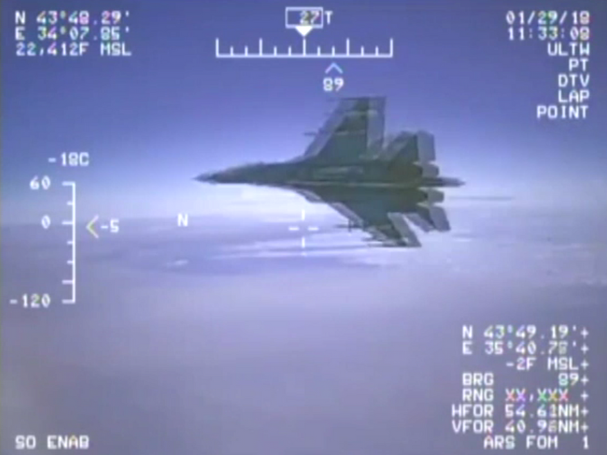 A Russian Su-27 jet careens past a U.S. Navy P-8 surveillance plane over the Baltic Sea, May 1, 2018. (Image: Fox News screenshot)