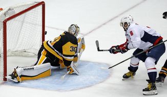 Washington Capitals&#39; Alex Ovechkin (8) puts the go-ahead goal behind Pittsburgh Penguins goaltender Matt Murray (30) during the third period in Game 3 of an NHL second-round hockey playoff series in Pittsburgh, Tuesday, May 1, 2018. The Capitals won 4-3. (AP Photo/Gene J. Puskar)