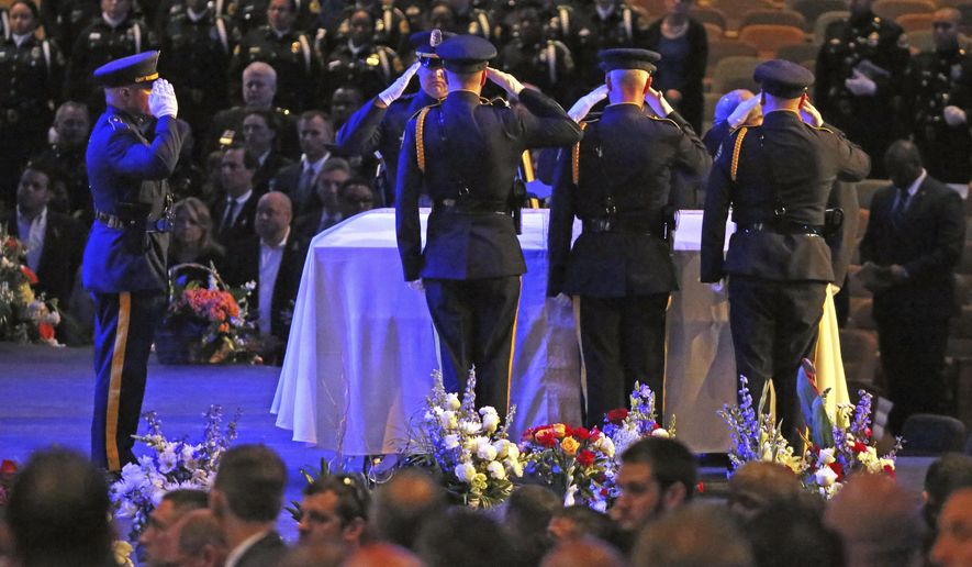 Colleagues salute their fallen comrade at the funeral for Dallas Police Officer Officer Rogelio Santander at Lake Pointe Church in Rockwall, Texas on Tuesday, May 1, 2018. Santander was shot and killed at a Home depot in Dallas last week. (Louis DeLuca/The Dallas Morning News via AP)