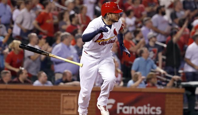 St. Louis Cardinals&#x27; Yadier Molina tosses his bat after hitting a walk-off single during the ninth inning of a baseball game against the Chicago White Sox Tuesday, May 1, 2018, in St. Louis. The Cardinals won 3-2. (AP Photo/Jeff Roberson)
