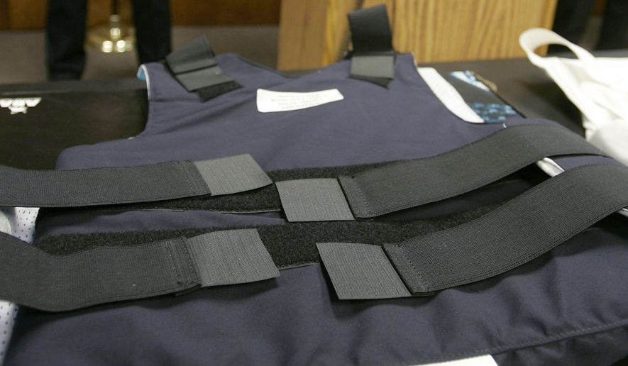 Arkansas Attorney General Mike Beebe, center, speaks at a Little Rock, Ark., news conference Thursday, April 20, 2006, as State Capitol Police Sgt. David Hughes, left, and Arkansas Highway Patrol Commander Maj. Ed Wolfe look on near an example of a new bulletproof vest made by American Body Armor that some agencies will begin using. Beebe says four state law enforcement agencies will receive a total of $427,000 from a class-action lawsuit over defective body armor vests from another manufacturer that were sold to the agencies. (AP Photo/Danny Johnston) **FILE**