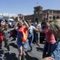 Supporters of opposition lawmaker Nikol Pashinian dance in Republic Square in Yerevan on Wednesday, May 2, 2018. Pashinyan has urged his supporters to block roads, railway stations and airports on Wednesday after the governing Republican Party voted against his election as prime minister. (AP Photo/Sergei Grits)