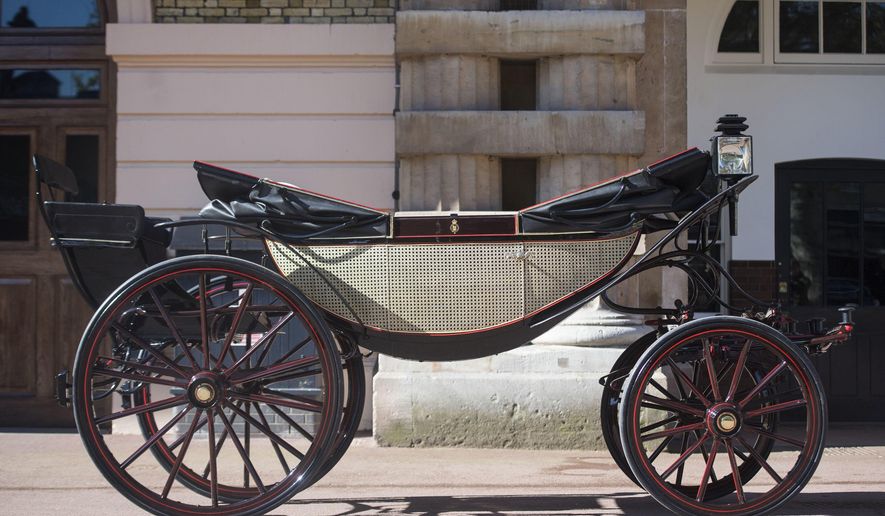 The Ascot Landau open carriage, which will be used in the case of dry weather, for the wedding of Britain's Prince Harry and Meghan Markle, stands ready in the Royal Mews at Buckingham Palace in London, Tuesday May 1, 2018. Prince Harry and Meghan Markle will tie the knot at St. George's Chapel in Windsor, southern England on May 19, with about 600 guests and some 2,600 neighbours, staff and specially selected members of the public greeting the happy couple outside the chapel. The Scottish State Coach will be used in the case of wet weather. (Victoria Jones/Pool via AP)