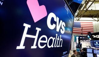 FILE- In this Dec. 4, 2017, file photo, the CVS Health logo appears above a trading post on the floor of the New York Stock Exchange. CVS Health reports earnings Wednesday, May 2, 2018. (AP Photo/Richard Drew, File)