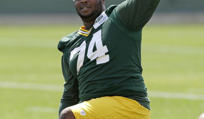 FILE - In this Tuesday, June. 17, 2014, file photo, Green Bay Packers Carlos Gray gestures during an NFL football mini-camp practice, in Green Bay, Wis. Authorities say a former Green Bay Packers player has been found shot to death in his home in Alabama. The Jefferson County Coroner&#x27;s Office says former Packers defensive lineman Carlos Gray was found shortly before 10 p.m. Monday, April 30, 2018, near Birmingham, Alabama. The 25-year-old is a native of Pinson, Alabama. (AP Photo/Mike Roemer, File)