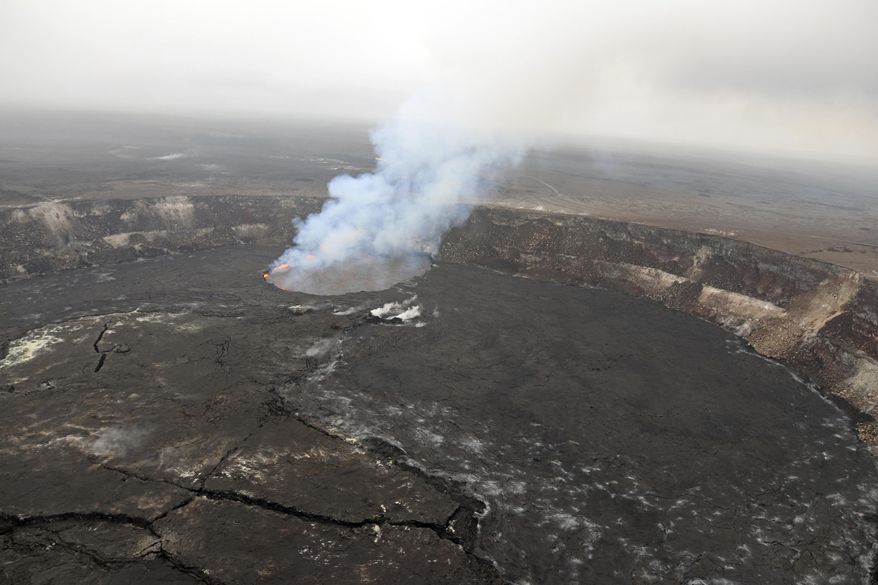 This May 1, 2018 photo provided by the U.S. Geological Survey shows the eruption at the summit of Kilauea Volcano near Honolulu, Hawaii. Dozens of earthquakes are rattling Hawaii's Kilauea Volcano as magma flows into a new area east of the Puu Oo vent. Officials with the U.S. Geological Survey's Hawaiian Volcano Observatory say the increased activity Wednesday, May 2, 2018, is associated with the collapse of the crater floor at the Puu Oo vent. (U.S. Gelological Survey via AP)