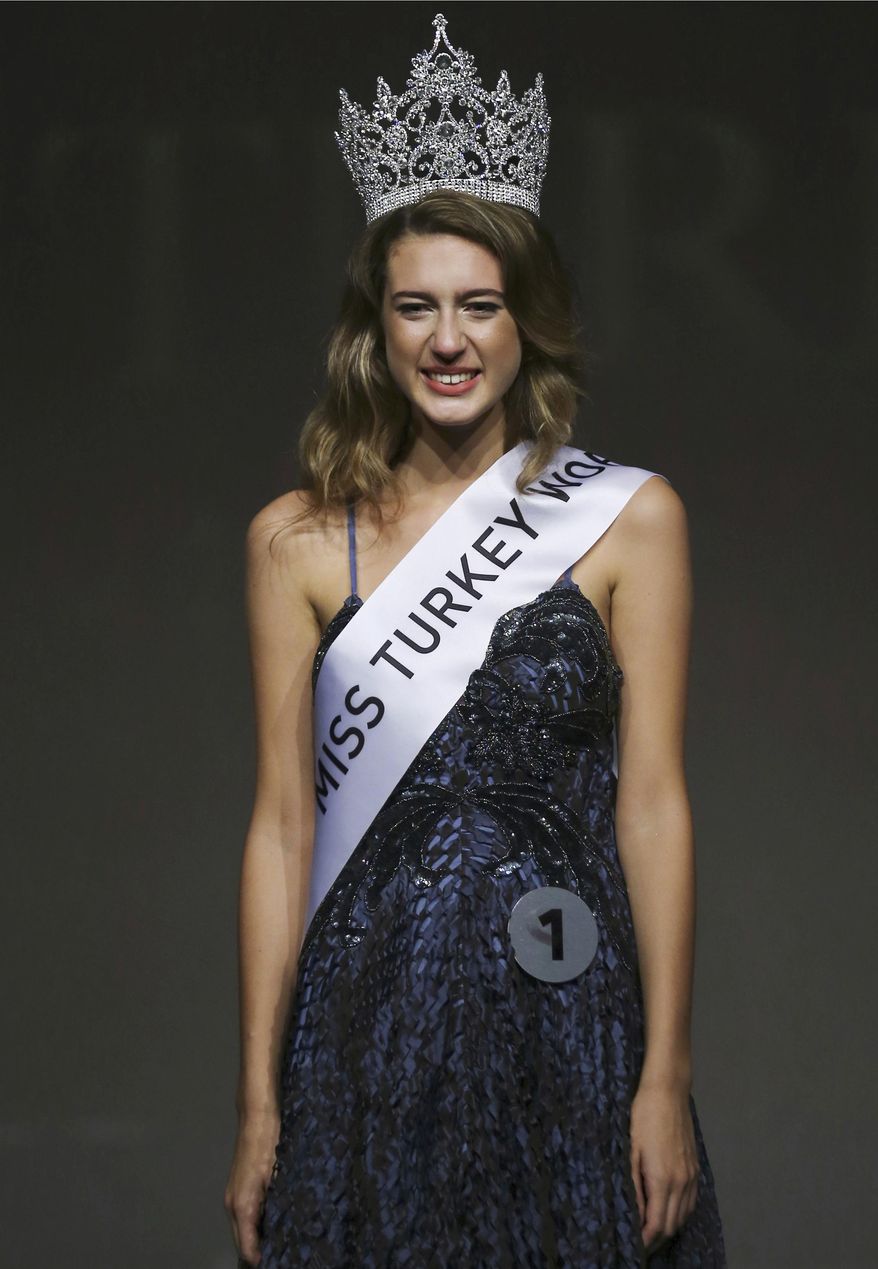FILE - In this Thursday, Sept. 21, 2017 file photo, Itir Esen, 18, smiles after being crowned Miss Turkey 2017 in Istanbul. A court has acquitted on Thursday, May 3, 2018 the former beauty queen of charges of "insulting" the victims of a failed 2016 coup over a Twitter posting that had caused uproar. Esen was stripped of her Miss Turkey 2017 title and was later charged with insulting a section of the public for the tweet she posted as the country held memorials marking the failed coup. (AP Photo, File)