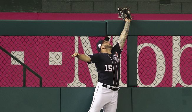 Washington Nationals left fielder Matt Adams leaps to make a catch on a ball hit by Philadelphia Phillies' Maikel Franco during the fourth inning of a baseball game at Nationals Park, Friday, May 4, 2018, in Washington. (AP Photo/Pablo Martinez Monsivais)