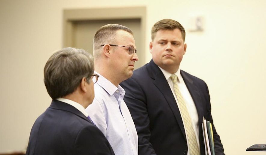 in this Thursday, May 3, 2018 photo, Douglas Crystal, center, appears his sentencing at the Kent County Courthouse in Grand Rapids, Mich. Crystal, charged after fleeing a high-speed crash that killed a woman and critically injured her 5-year-old twin boys in western Michigan, was sentenced to up to 15 years in prison. (Casey Sykes/The Grand Rapids Press via AP)