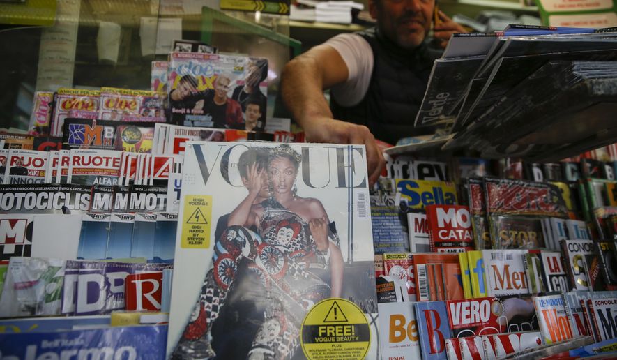 May Vogue Italia cover hits a newsstand in Milan, Italy, Friday, May 4, 2018. Gigi Hadid and Vogue Italia have separately apologized for the May Vogue Italia cover showing the top model with a darker skin tone and hair color that set off a social media backlash and underlined the lack of diversity in the fashion industry. The cover shot by Steven Klein shows the normally blonde Hadid with dark hair and heavily bronzed skin, wearing matching a Dolce & Gabbana sequined legging ensemble with matching tiara. Inside, Hadid poses in beachwear in the spread titled ‘’High Voltage.’’ (AP Photo/Luca Bruno)