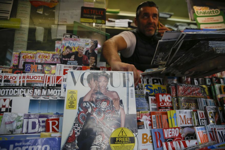 May Vogue Italia cover hits a newsstand in Milan, Italy, Friday, May 4, 2018. Gigi Hadid and Vogue Italia have separately apologized for the May Vogue Italia cover showing the top model with a darker skin tone and hair color that set off a social media backlash and underlined the lack of diversity in the fashion industry. The cover shot by Steven Klein shows the normally blonde Hadid with dark hair and heavily bronzed skin, wearing matching a Dolce & Gabbana sequined legging ensemble with matching tiara. Inside, Hadid poses in beachwear in the spread titled ‘’High Voltage.’’ (AP Photo/Luca Bruno)