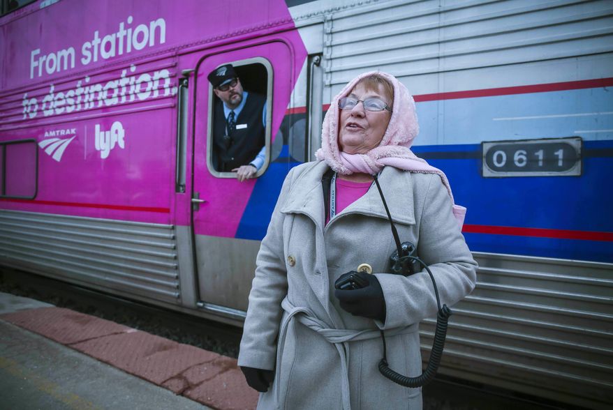 This April 10, 2018 photo shows Amtrak attendant, Pat Green, as the train approaches at the Osceola, Iowa, station April 10, 2018. Green has been an attendant for 32 years.(Rodney White/The Des Moines Register via AP)