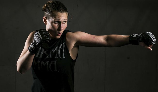 In this Thursday, April 26, 2018 photo, Kelly Clayton poses in Yakima, Wash. Clayton has put a dozen amateur MMA fights behind her and is now embarking on her pro debut. She made a decision to find herself, a journey that led her grappling, kicking and punching opponents in a cage. (Amanda Ray/Yakima Herald-Republic via AP)