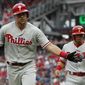 Philadelphia Phillies&#39; Rhys Hoskins, left, celebrates after hitting a two-run home run in the first inning of a baseball game against the Washington Nationals at Nationals Park, Saturday, May 5, 2018, in Washington. Phillies Cesar Hernandez, right,  also scored on the play. (AP Photo/Carolyn Kaster)