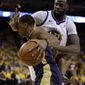 File-This April 28, 2018, file photo shows Golden State Warriors&#39; Draymond Green, top, defending against New Orleans Pelicans&#39; Rajon Rondo during the first half in Game 1 of an NBA basketball second-round playoff series in Oakland, Calif. Rondo and Green both have won NBA titles and neither has ever been known to shy away from conflict on the court. Now their combustible convergence in the playoffs is providing spicy subplot to the Western Conference semifinal series between New Orleans and Golden State.(AP Photo/Marcio Jose Sanchez, File)