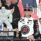Kevin Harvick, right, poses with the trophy in Victory Lane after he won the NASCAR Cup Series auto race, Sunday, May 6, 2018, at Dover International Speedway in Dover, Del. (AP Photo/Nick Wass)