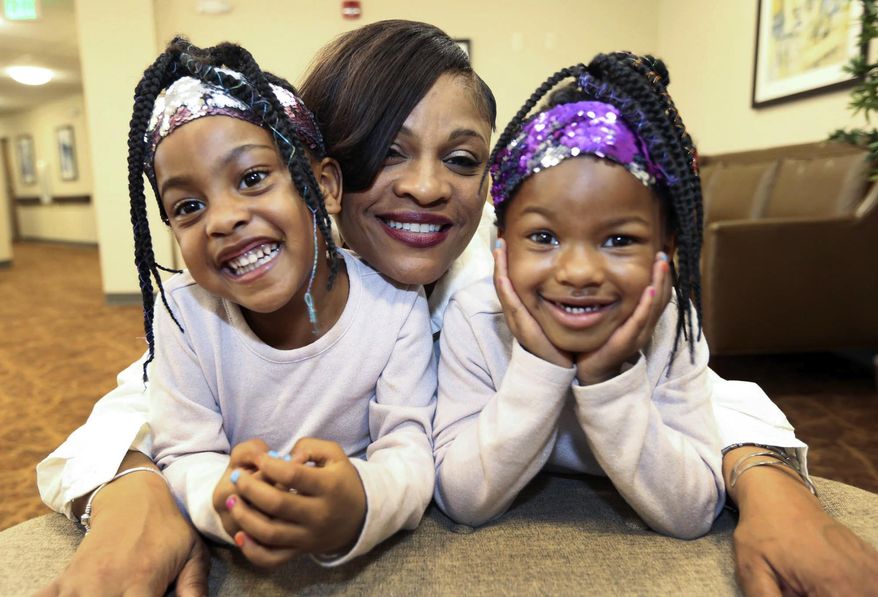 Tyhria Williams, formerly of East Chicago and Valparaiso, poses for a photo with granddaughters, Myla Williams, 4, left, and Kyla Williams, 5, in Merrilville, Ind. Tyhria recently published a book, "Pure Gold: Processed in the Fire," about her experience with drug addiction. (John Luke/The Times via AP)