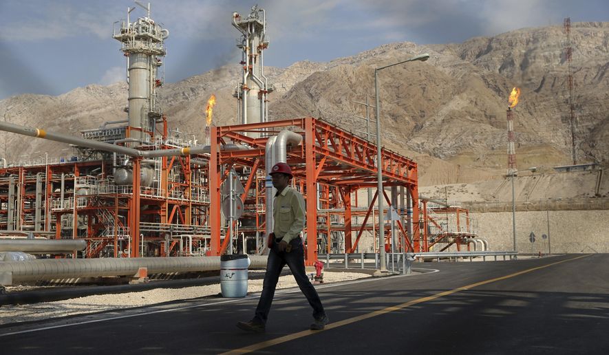FILE - In this Nov. 19, 2015 file photo, a worker makes his way in a natural gas refinery in the South Pars gas field in Asalouyeh, Iran, on the northern coast of Persian Gulf. From brand-new airplanes to oilfields, billions of dollars of deals stand on the line for international corporations as President Donald Trump weighs whether to pull America out of Iran&#x27;s nuclear deal with world powers. (AP Photo/Ebrahim Noroozi, File)