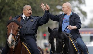 FILE - In this Feb. 13, 2018, file photo, New Orleans Mayor Mitch Landrieu, right, and chief of police Michael Harrison ride on horseback at the start of the Krewe of Zulu parade on Mardi Gras day in New Orleans. In many ways, Landrieu leaves the New Orleans mayor&#39;s office Monday, May 7, on high notes. But the term-limited Democrat leaves stubborn problems for his successor, LaToya Cantrell. They include an aging water, sewerage and drainage system and recurring violent crime. (AP Photo/Gerald Herbert, File)