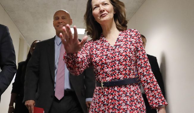 CIA Director nominee Gina Haspel, waves as she arrives for her meeting with Sen. Joe Manchin, D-W.Va., on Capitol Hill in Washington, Monday, May 7, 2018. Walking with her is White House legislative affairs director Marc Short, left. (AP Photo/Pablo Martinez Monsivais)
