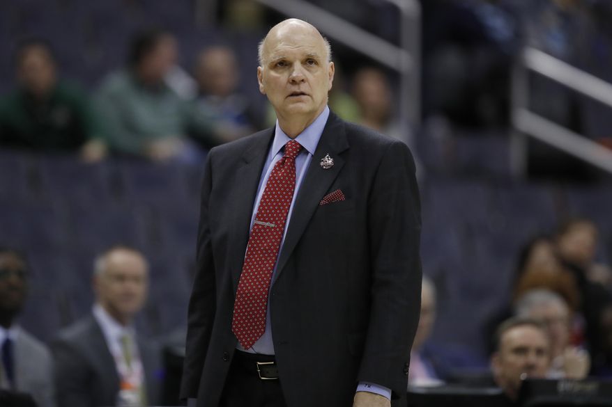 This March 9, 2018 photo shows Saint Joseph's head coach Phil Martelli watching his team during the second half of an NCAA college basketball quarterfinal game against George Mason in the Atlantic 10 Conference tournament in Washington. Martelli said Monday, May 7, 2018 that everyone involved in college basketball needs to help "create a new model" following recent reform proposals amid a federal corruption investigation into the sport. (AP Photo/Alex Brandon)