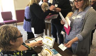 In a Wednesday, April 18. 2018 photo, Ella Wood, a participant in a reentry simulation, drops her &amp;quot;children&amp;quot; off at school during the event at the Rhodes Grove Conference Center in Chambersburg, Pa. The simulation gave participants the chance to experience the re-entry process as either an ex-offender or an ex-offender&#39;s family member.  (Ashley Books /Public Opinion via AP)