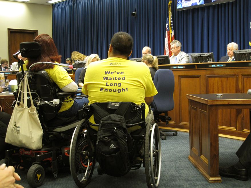 People wait in the Senate Finance Committee to testify about their concerns about budget cuts proposed for the upcoming financial year, on Monday, May 7, 2018, in Baton Rouge, La. The committee heard from dozens of people worried that the House-approved version of next year's budget would cut their services. (AP Photo/Melinda Deslatte)