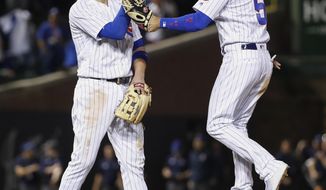 Chicago Cubs&#39; Kris Bryant, left, and Albert Almora Jr., right, celebrate the team&#39;s 14-2 win over the Miami Marlins in a baseball game, Monday, May 7, 2018, in Chicago. (AP Photo/Kamil Krzaczynski)