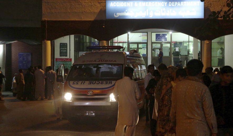 An ambulance is parked outside accident and emergency department of a hospital, where Pakistan's injured Interior Minister Ahsan Iqbal being shifted for treatment, in Lahore, Pakistan, Sunday, May 6, 2018. A gunman opened fire on the country's interior minister after a public meeting in his constituency Sunday, wounding him in the shoulder, officials said. (AP Photo/K.M. Chaudary)