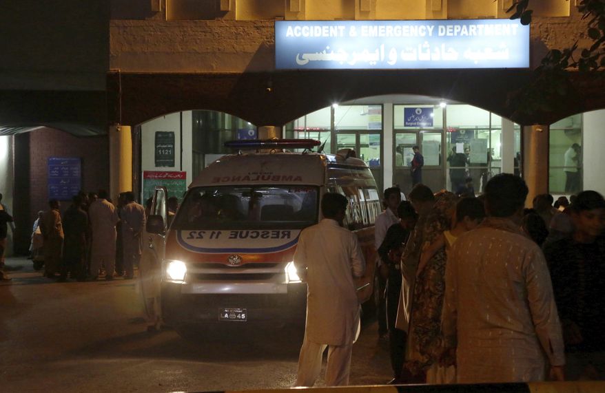 An ambulance is parked outside accident and emergency department of a hospital, where Pakistan's injured Interior Minister Ahsan Iqbal being shifted for treatment, in Lahore, Pakistan, Sunday, May 6, 2018. A gunman opened fire on the country's interior minister after a public meeting in his constituency Sunday, wounding him in the shoulder, officials said. (AP Photo/K.M. Chaudary)