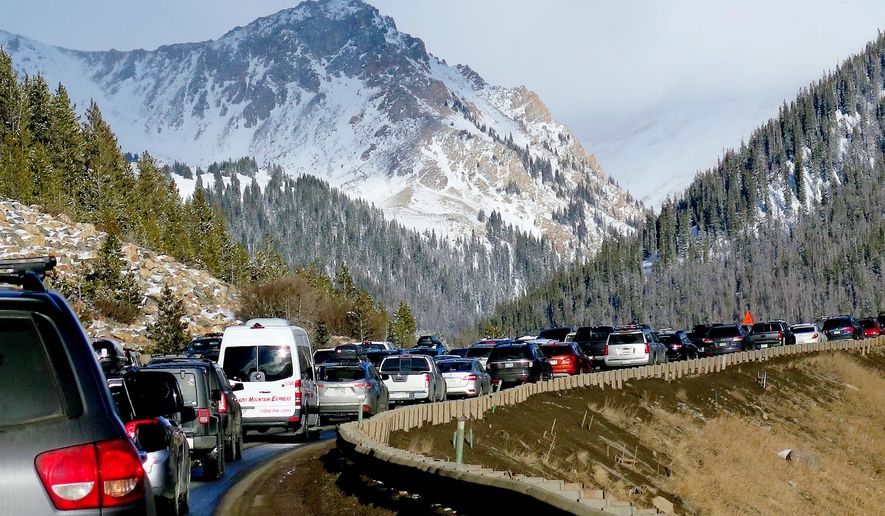 FILE - In this Jan. 7, 2018, file photo, traffic backs up on Interstate 70 near Silvethorne, Colo., a familiar scene on the main highway connecting Denver to the mountains. Top Colorado lawmakers say they have struck a deal on transportation funding. The compromise would ask voters in 2019 to borrow $2.34 billion for transportation projects. (AP Photo/Thomas Peipert, File)
