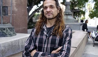 Matthew Lentz, who says he was fathered by convicted murderer Charles Manson at an orgy, stands outside Los Angeles Superior Court Tuesday, May 8, 2018. He carried letters he said Manson sent him from prison and hoped to show them to a judge at a hearing over claims on Manson&#39;s estate. But he arrived too late for the hearing, and has until July 13 to show cause why he shouldn&#39;t be dismissed from the case. (AP Photo/Brian Melley)
