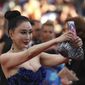 A guest takes a selfie photograph upon arrival at the opening ceremony of the 71st international film festival, Cannes, southern France, Tuesday, May 8, 2018. (Photo by Vianney Le Caer/Invision/AP)